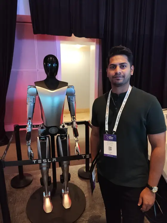 Mirza Umer beside a Tesla Optimus robot